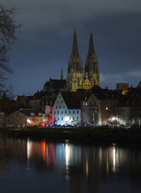 Reflection of illuminated buildings in city at night