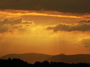 Silhouette of mountain range at sunset