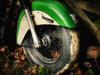 Close-up of bicycle wheel on field