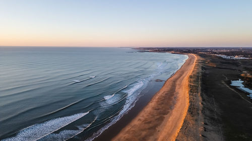 Scenic view of sea against clear sky during sunset