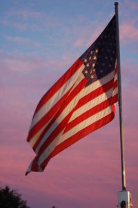 Low angle view of american flag against sky