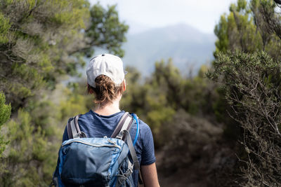 Rear view of woman hiking on trails