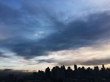 Cityscape against cloudy sky