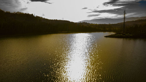 Scenic view of lake against sky at sunset