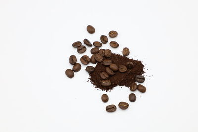 High angle view of coffee beans against white background