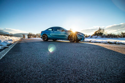 Car on road against sky during sunny day