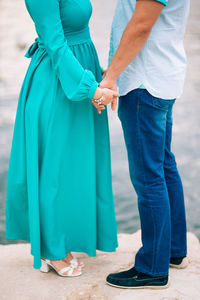 Low section of couple standing outdoors