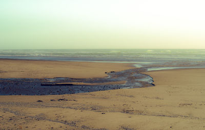 Scenic view of beach against clear sky