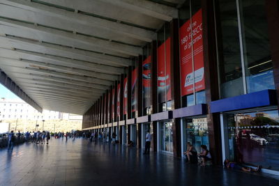 People walking in corridor of building