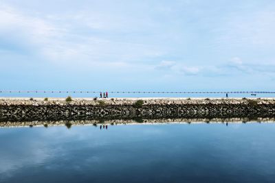 Scenic view of sea against cloudy sky