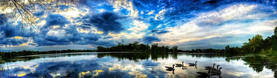 Scenic view of lake against cloudy sky