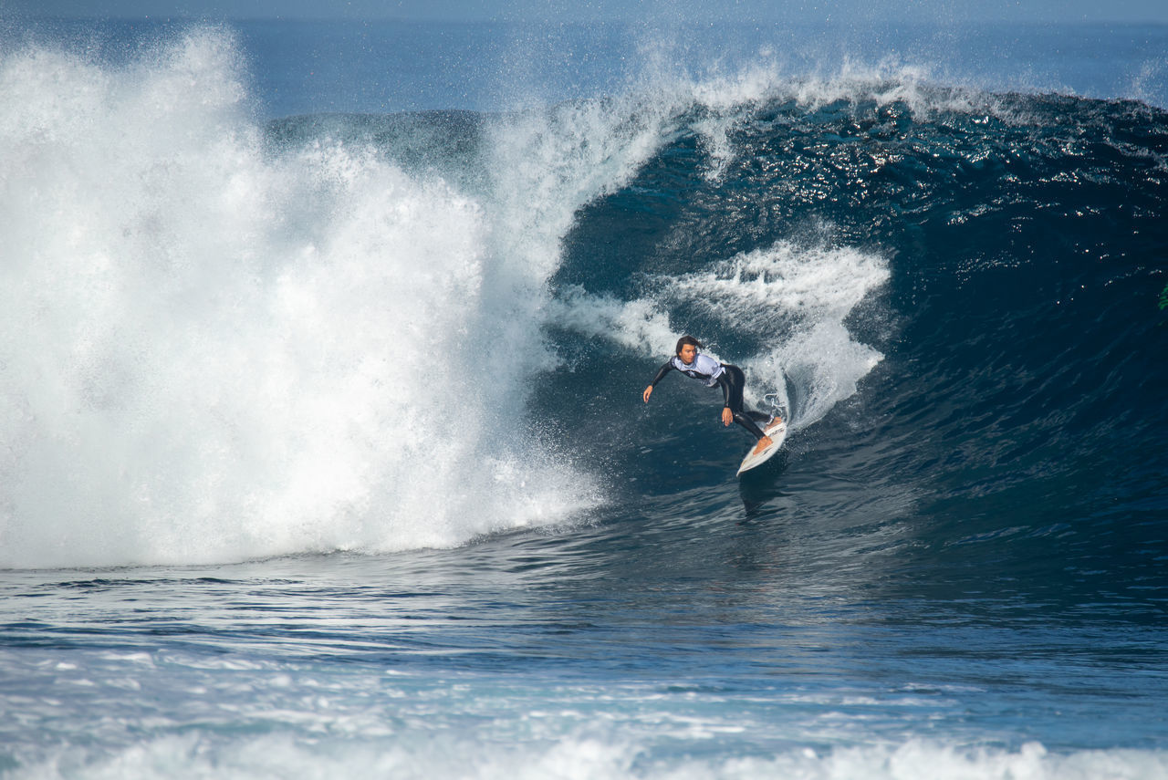 MAN SURFING ON SEA