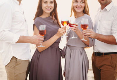 Couples holding wineglass