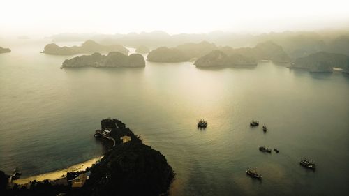 High angle view of rocks in sea against sky