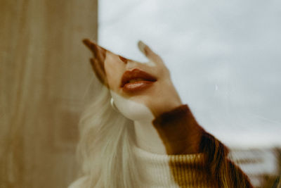 Close-up of woman face seen through glass