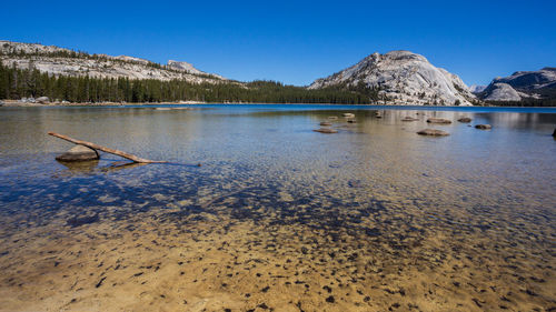 Scenic view of lake against clear blue sky