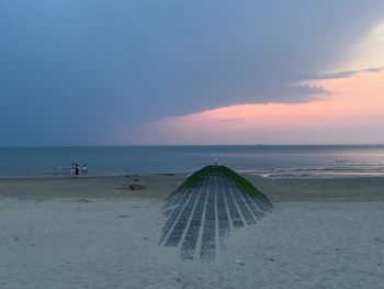 Scenic view of beach against sky during sunset