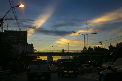 Traffic on road at sunset