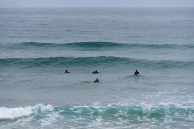 High angel view of people swimming in sea