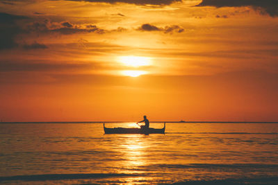 Scenic view of sea against orange sky during sunset