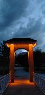 Illuminated bridge against sky at dusk