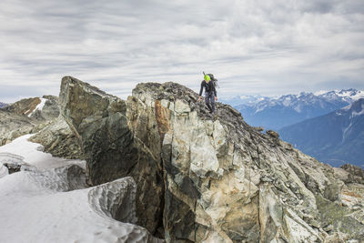 Backpacker hiking across rocky ridge in b.c.