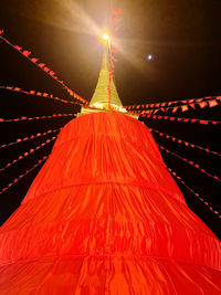 Low angle view of illuminated temple against sky at night