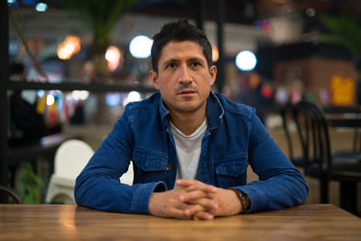Portrait of man sitting in restaurant