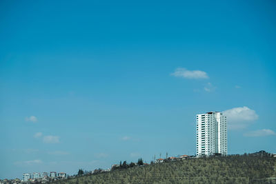 Low angle view of buildings against blue sky