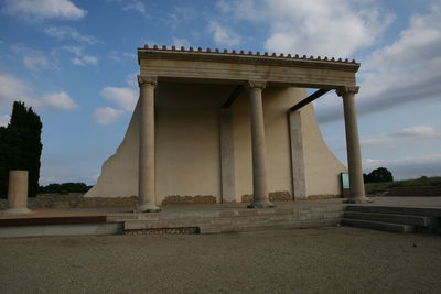 Low angle view of historical building against cloudy sky