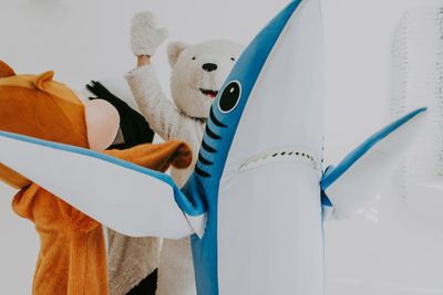 People wearing costume standing over white background