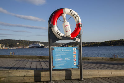 View of signboard against calm sea