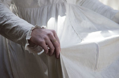 Close-up of woman holding her dress