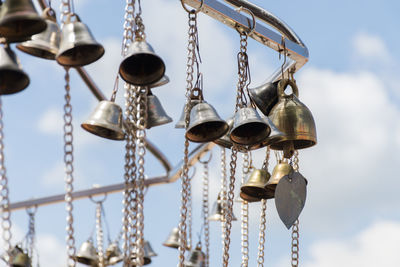 Low angle view of chain hanging against sky