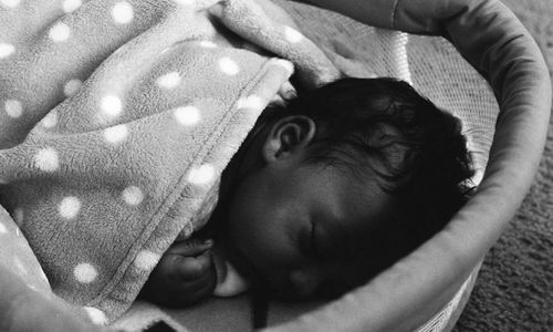 Close-up of baby lying on hand