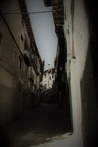 Buildings in town against sky