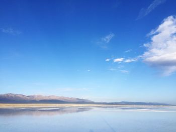 Scenic view of lake against blue sky