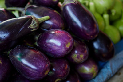 Pile of fresh purple eggplant for sale at market