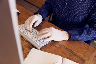 High angle view of man using laptop on table