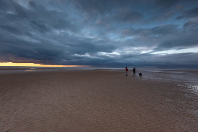 Scenic view of beach against sky during sunset