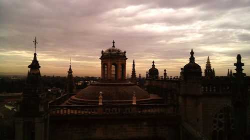 Buildings in city against sky during sunset