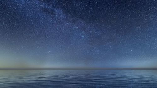 Scenic view of sea against sky at night