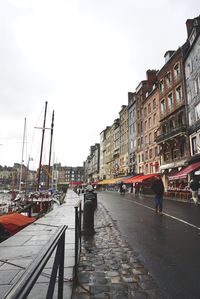 Panoramic view of people in city against clear sky