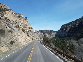 Road by mountain against clear sky