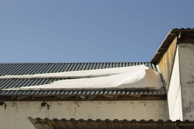 Snow on roof. roof of building in winter. architectural details. steel coating.