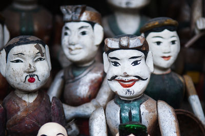 Close-up of wooden puppets for sale at market stall