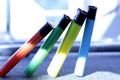 Close-up of multi colored bottles on table