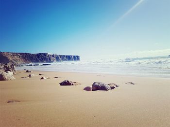 Scenic view of beach against clear sky