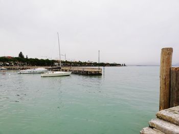 Sailboats in sea against sky