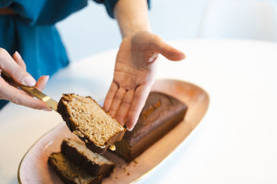 Woman cuts healthy banana bread